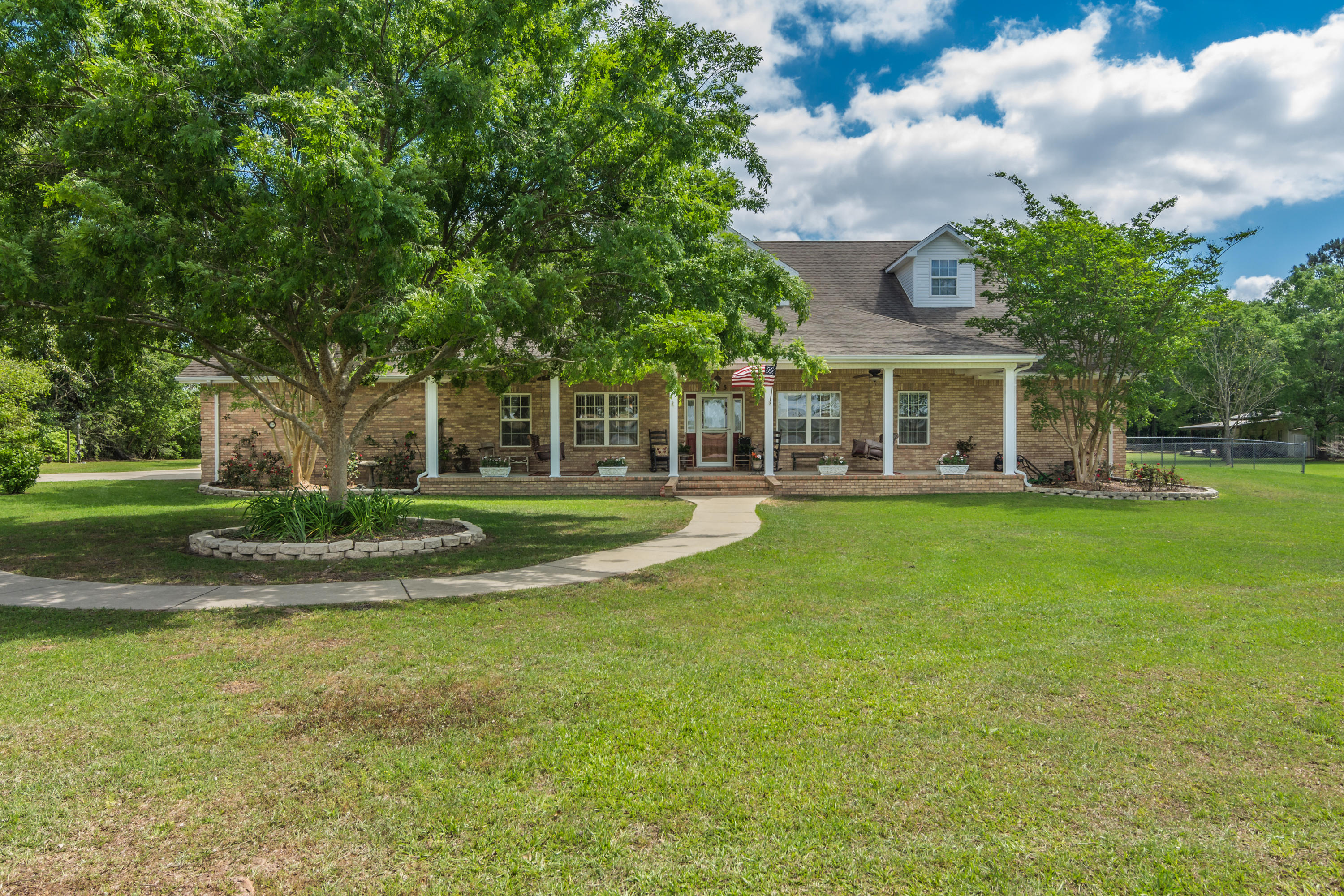 5995 Jack Stokes Road Baker, FL 32531 - Photo 2 of 60 a view of house with a big yard and large trees