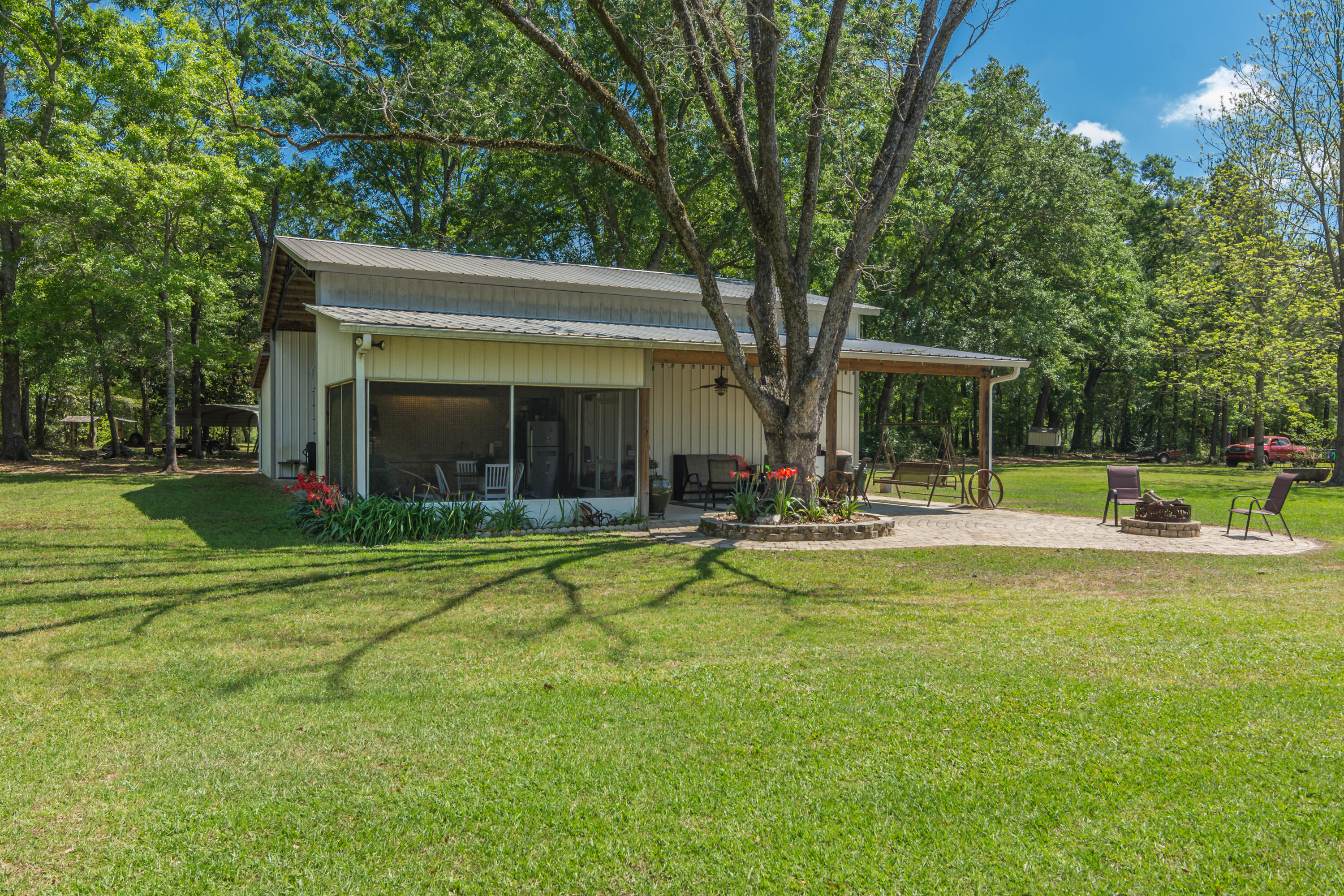 5995 Jack Stokes Road Baker, FL 32531 - Photo 16 of 60 a view of swimming pool with lawn chairs and large trees