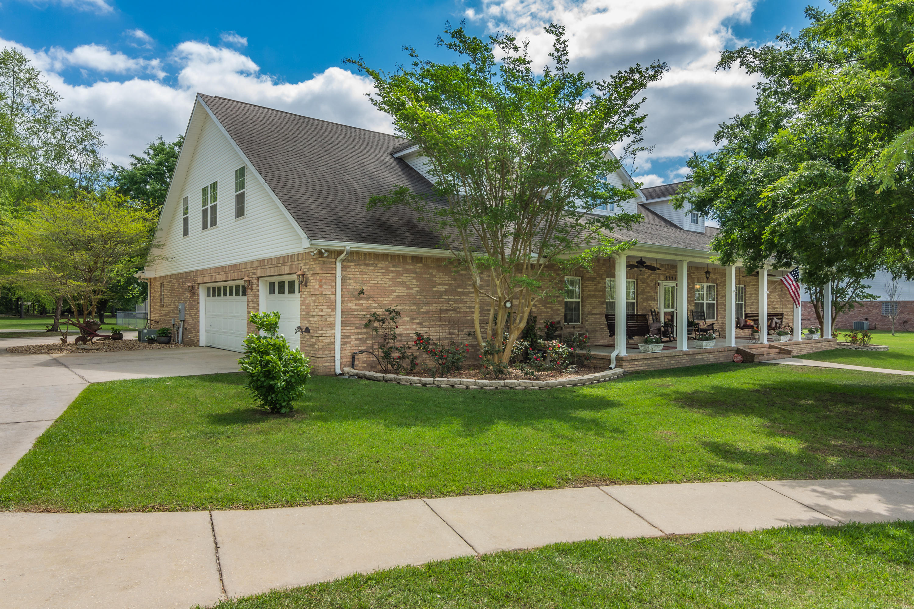 5995 Jack Stokes Road Baker, FL 32531 - Photo 3 of 60 a front view of a house with a garden and yard