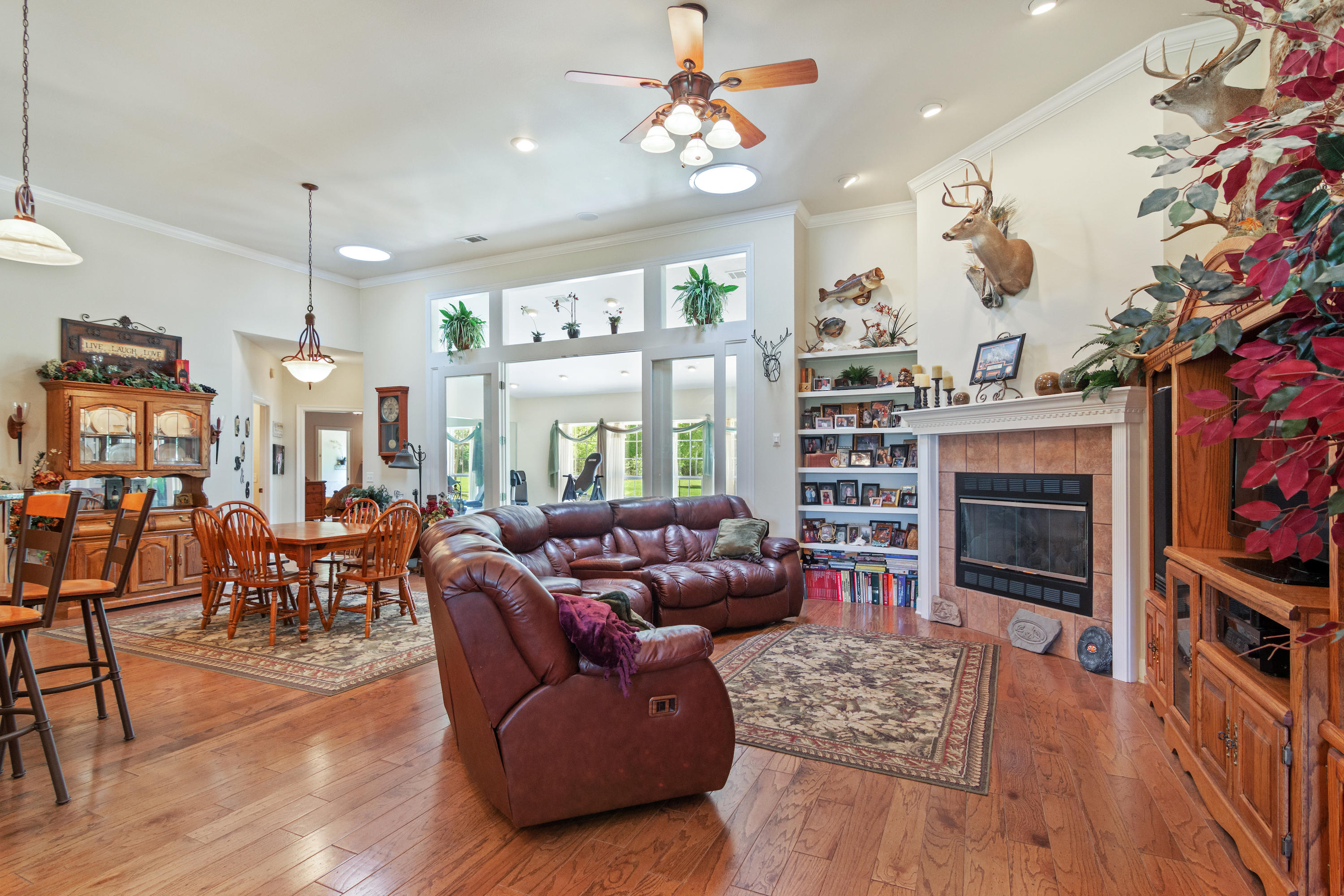 5995 Jack Stokes Road Baker, FL 32531 - Photo 25 of 60 a living room with furniture a fireplace and a flat screen tv