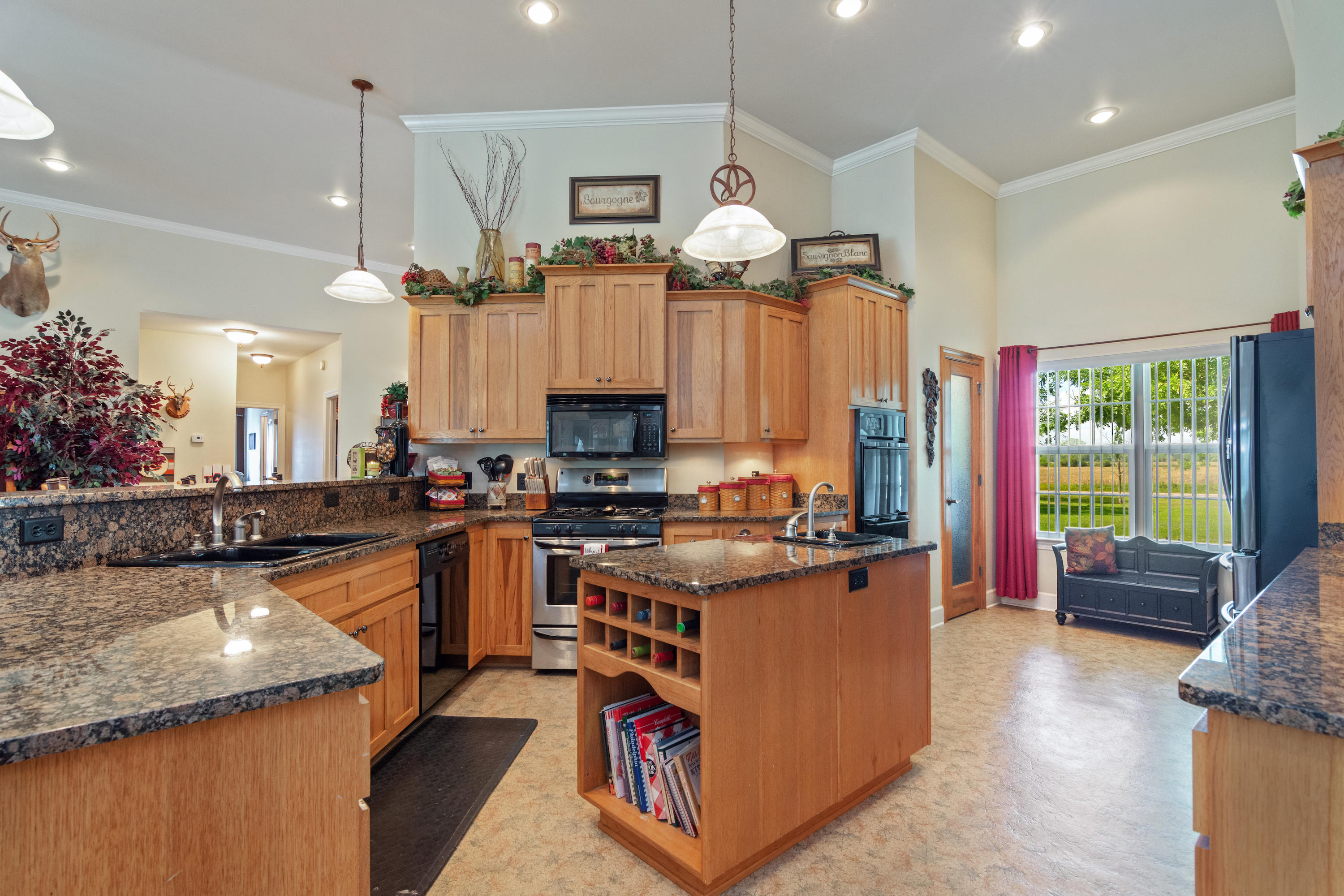 5995 Jack Stokes Road Baker, FL 32531 - Photo 30 of 60 a kitchen with a stove a refrigerator and a fireplace