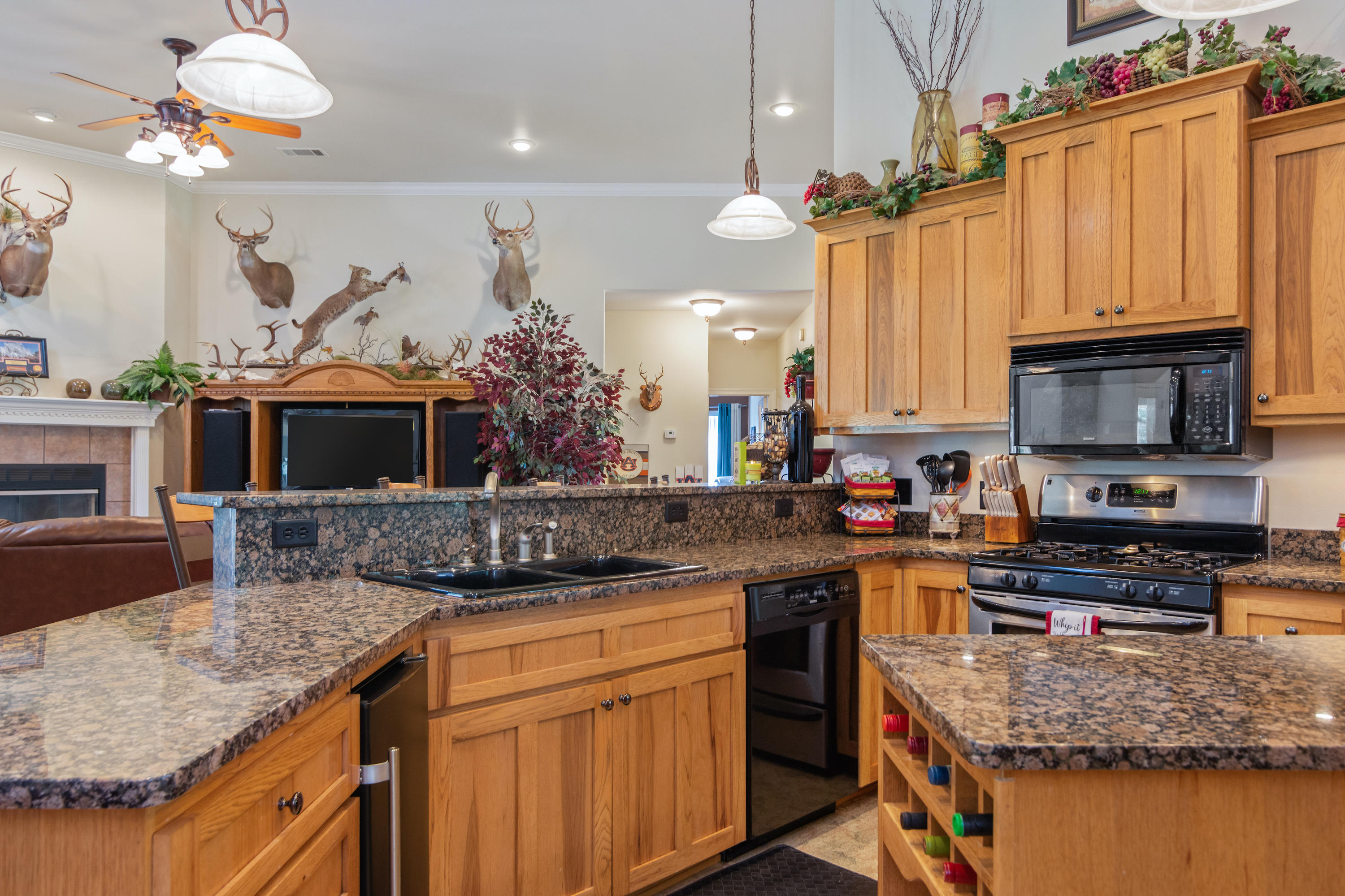 5995 Jack Stokes Road Baker, FL 32531 - Photo 31 of 60 a kitchen with stainless steel appliances granite countertop a sink a stove and a wooden cabinets