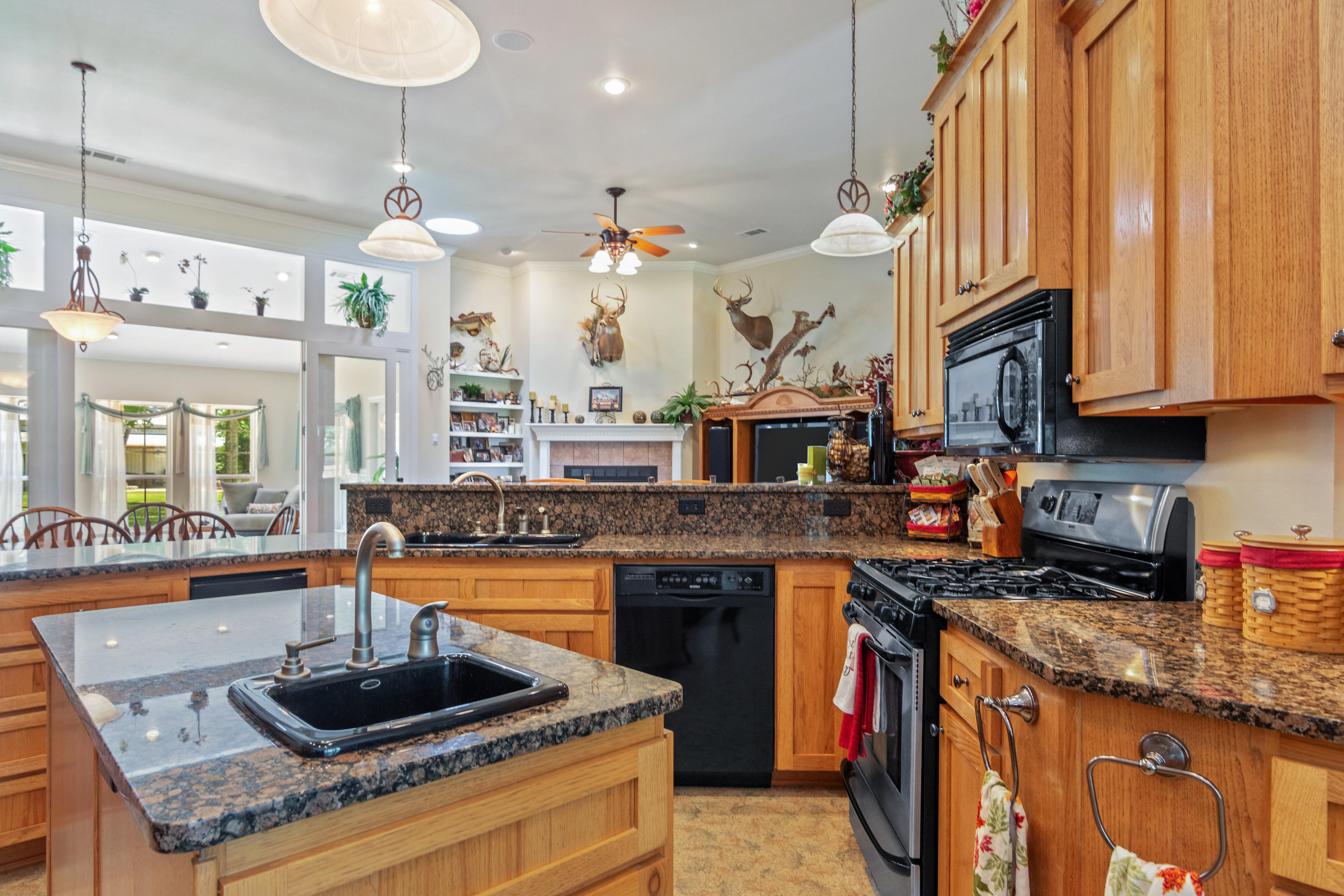 5995 Jack Stokes Road Baker, FL 32531 - Photo 34 of 60 a kitchen with stainless steel appliances granite countertop a stove a sink and a microwave