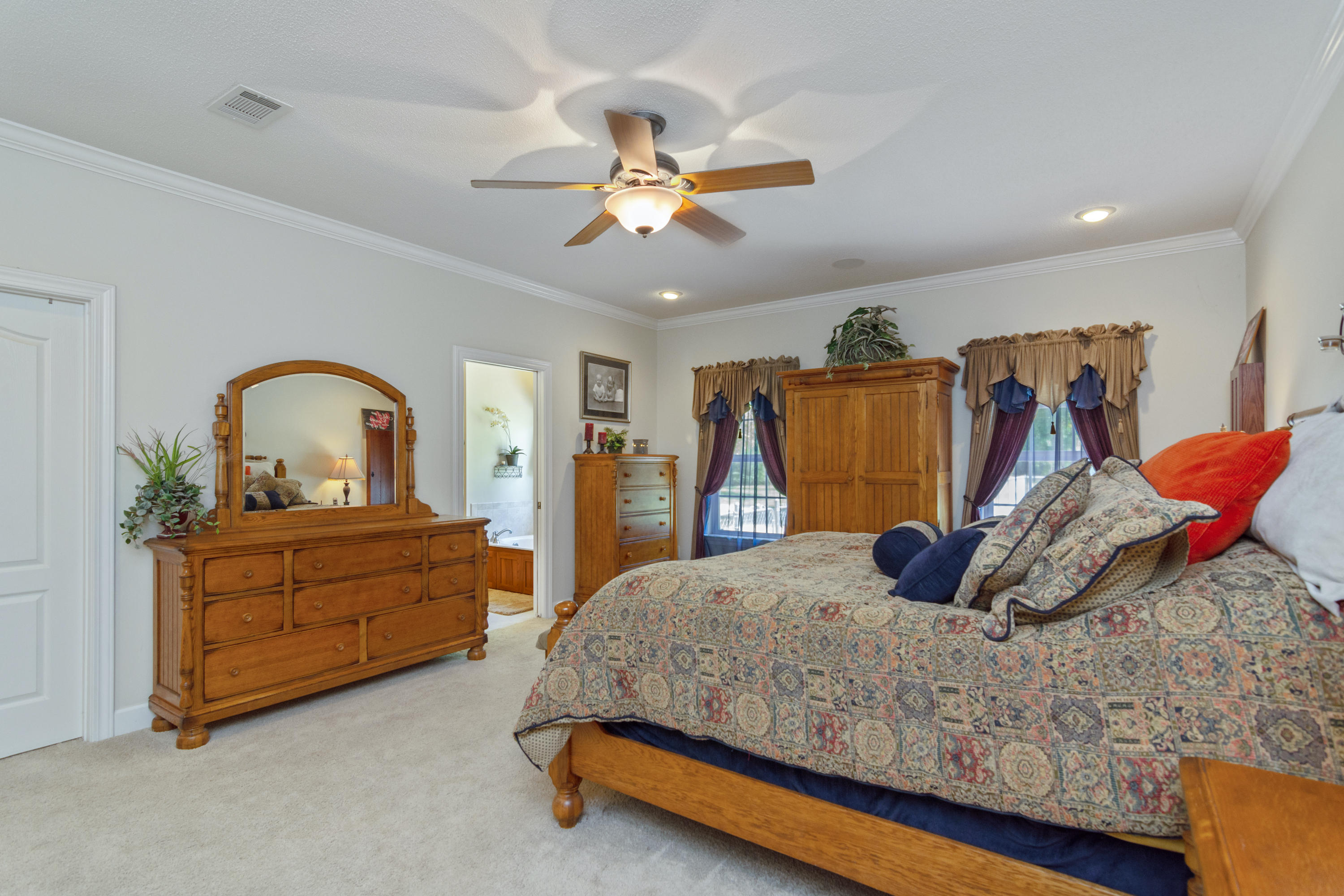 5995 Jack Stokes Road Baker, FL 32531 - Photo 36 of 60 a bedroom with a bed and a dresser