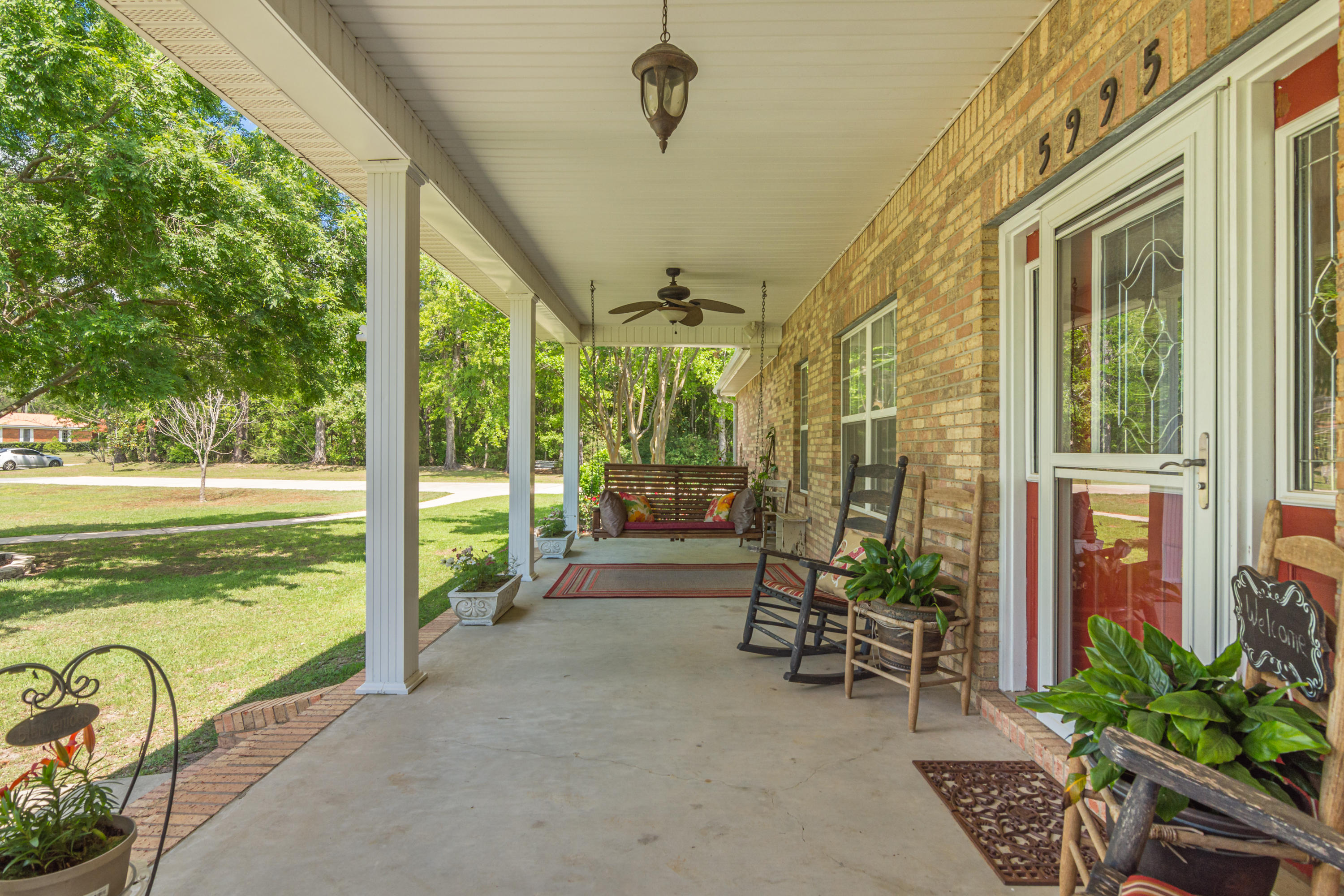 5995 Jack Stokes Road Baker, FL 32531 - Photo 5 of 60 a view of a porch with chairs and backyard