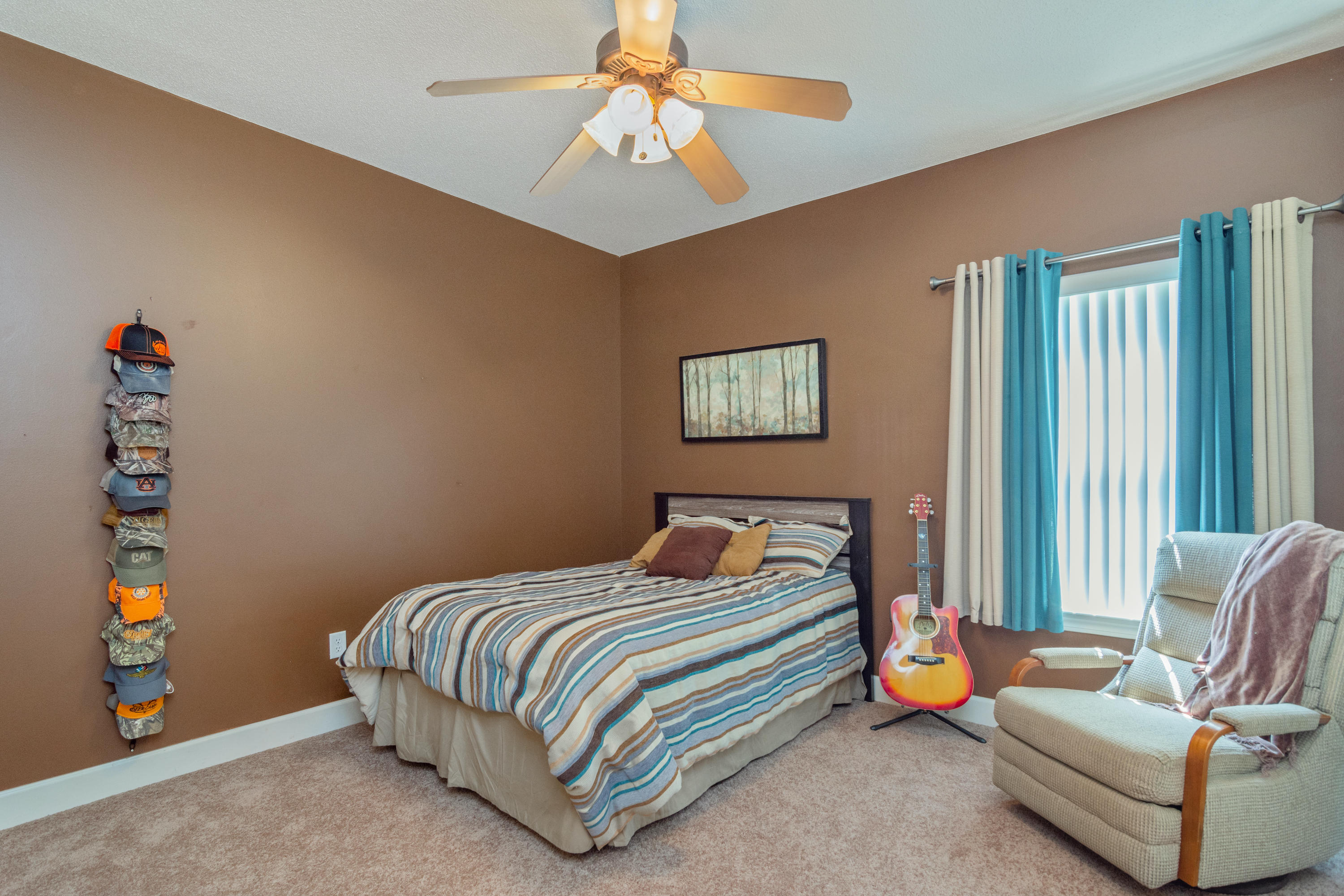 5995 Jack Stokes Road Baker, FL 32531 - Photo 46 of 60 a bedroom with a bed and a chandelier