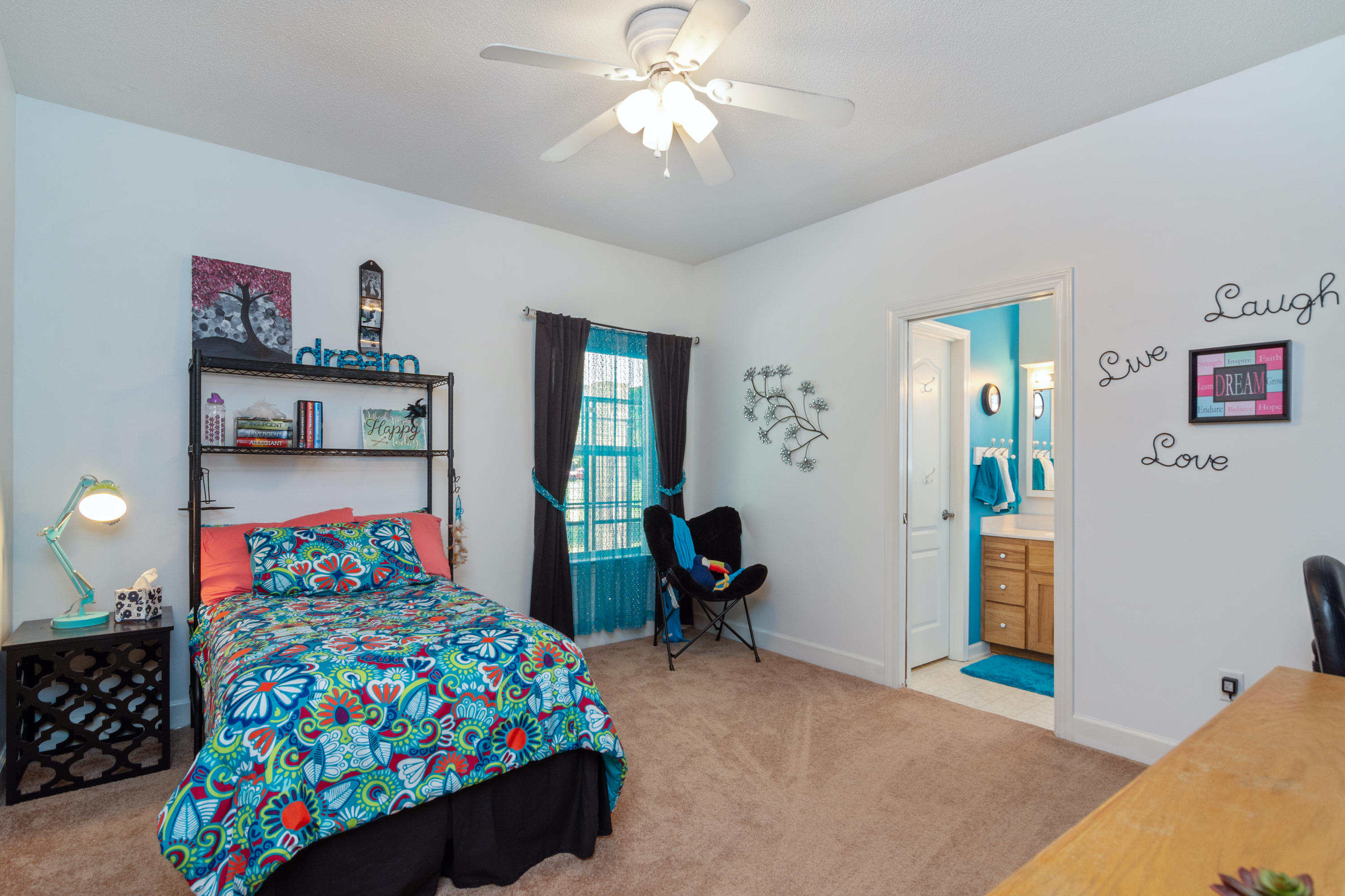 5995 Jack Stokes Road Baker, FL 32531 - Photo 50 of 60 a bedroom with a bed and large windows