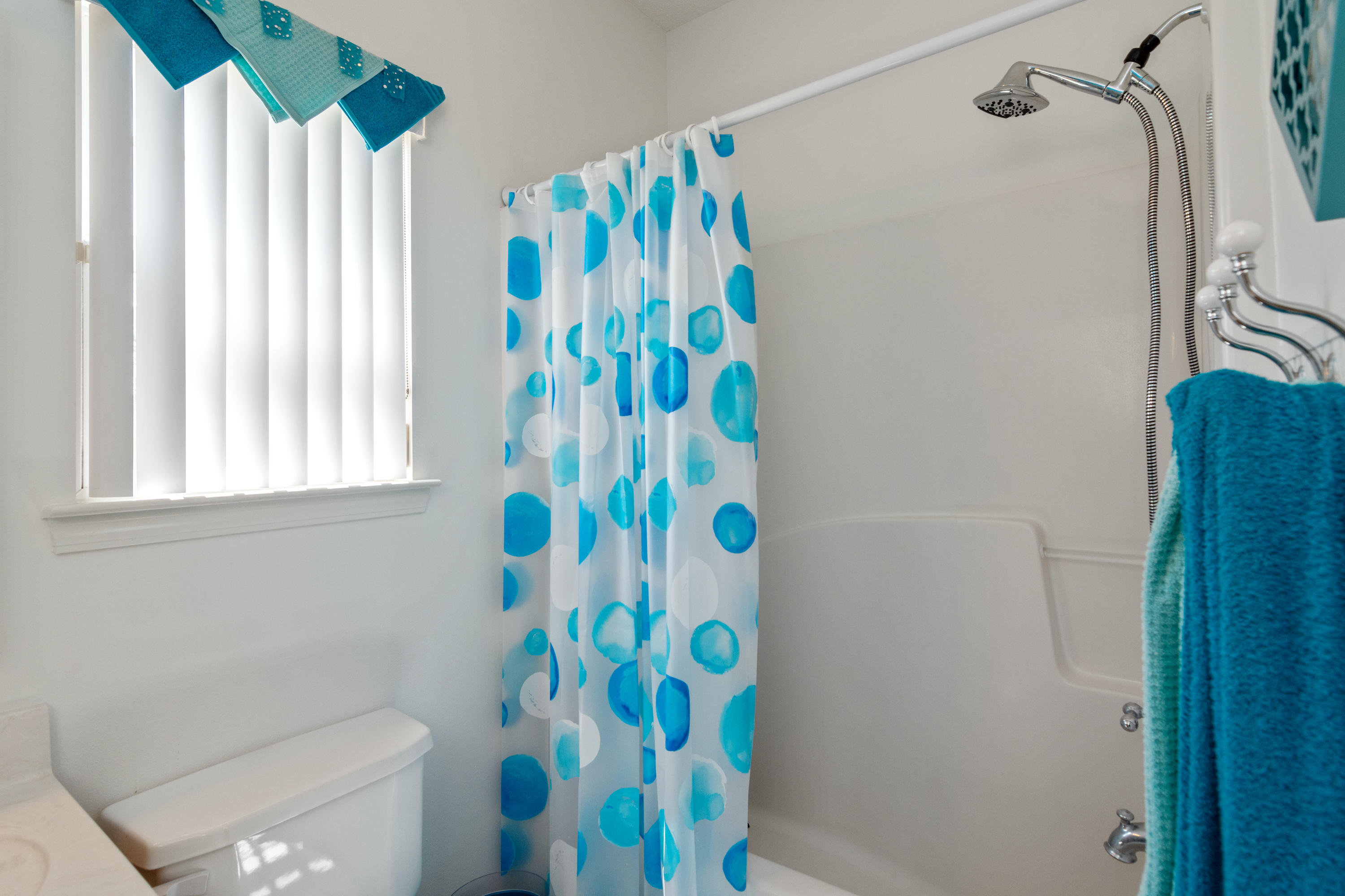 5995 Jack Stokes Road Baker, FL 32531 - Photo 53 of 60 a bathroom with a sink a toilet and shower curtain