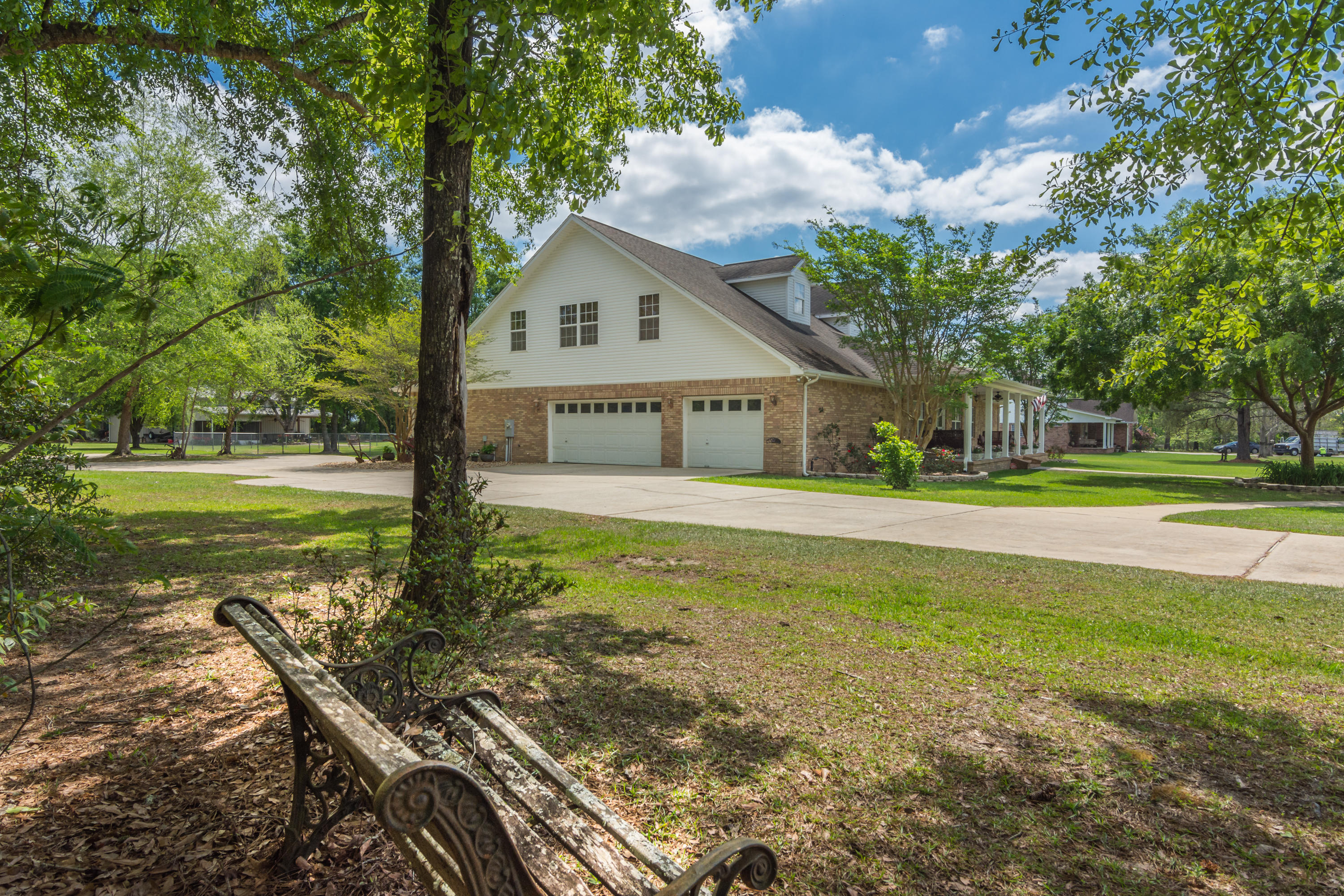 5995 Jack Stokes Road Baker, FL 32531 - Photo 8 of 60 a front view of a house with garden