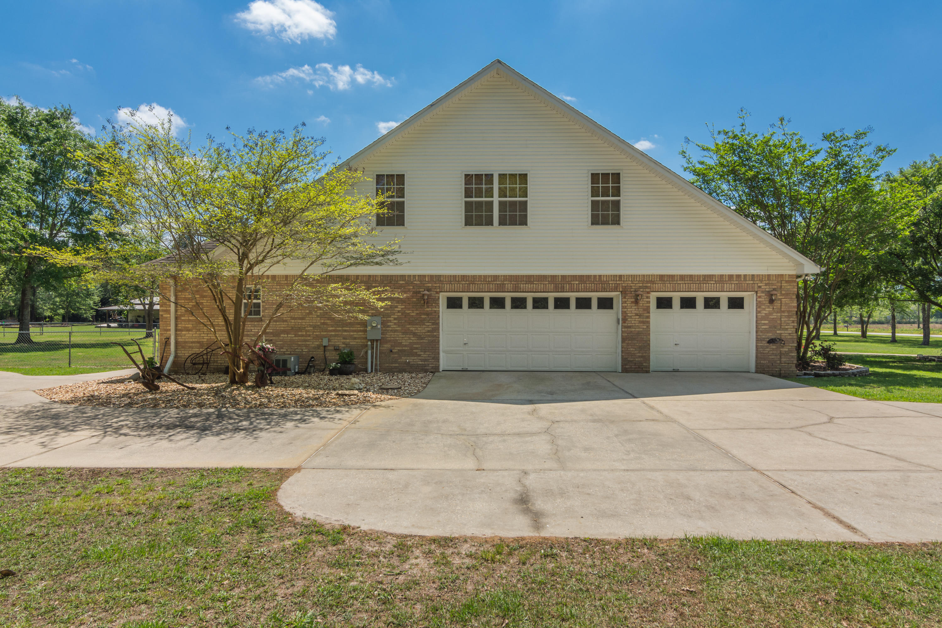 5995 Jack Stokes Road Baker, FL 32531 - Photo 9 of 60 a view of a house with a yard and garage