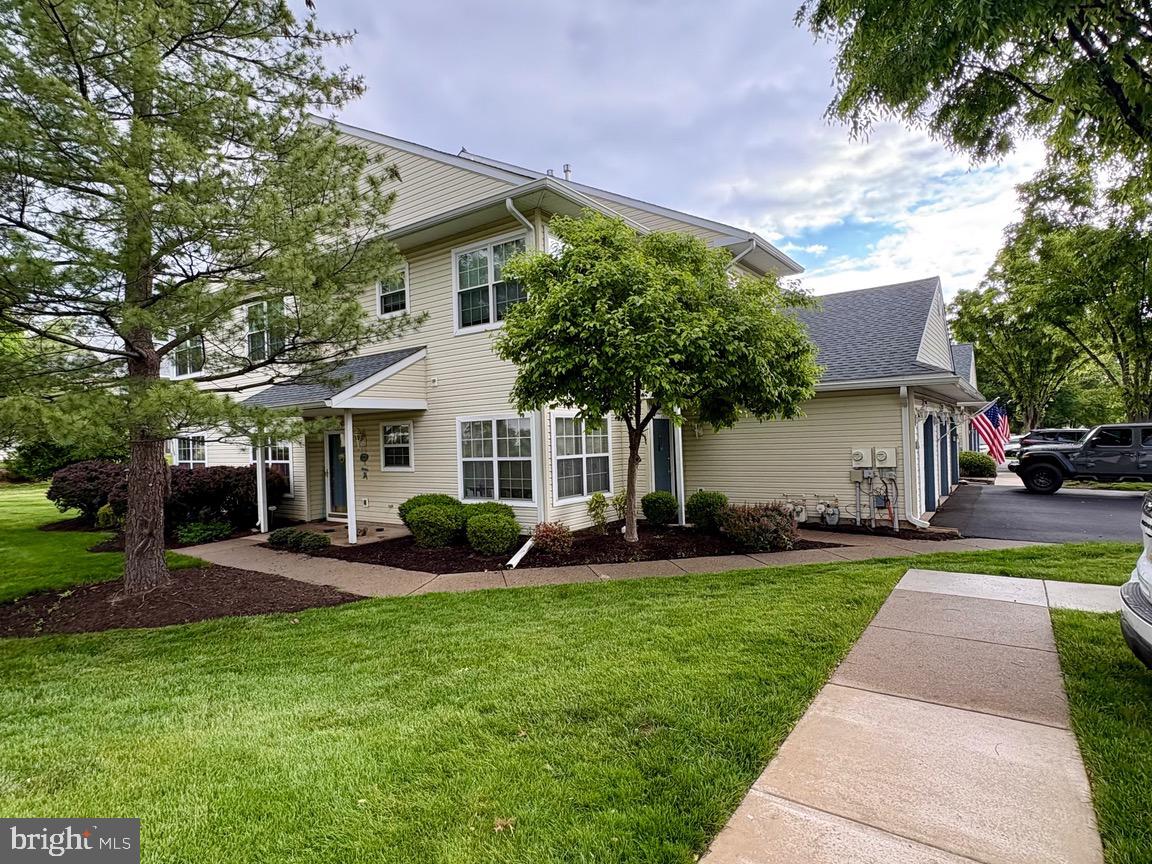 2402 Waterford Road, Unit 94 Yardley, PA 19067 - Photo 26 of 28 a front view of a house with a yard and trees