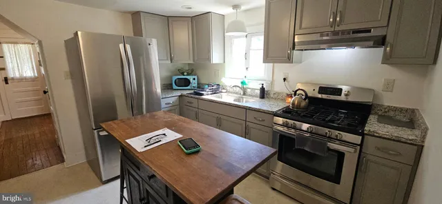 a kitchen with a sink appliances and cabinets