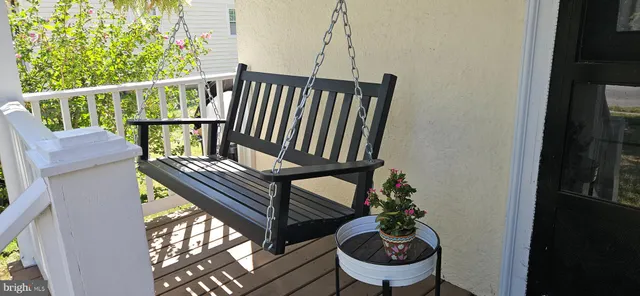a view of a balcony with chairs and wooden floor