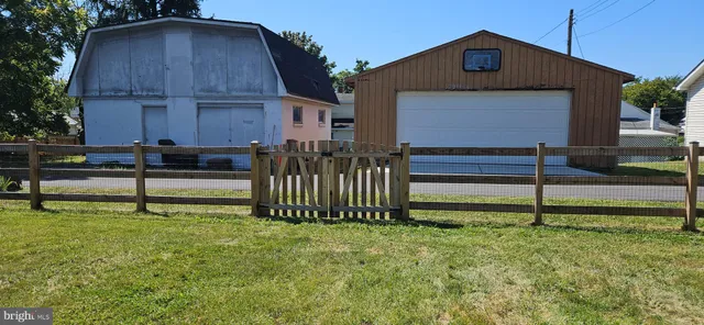 a tall house with trees in the background