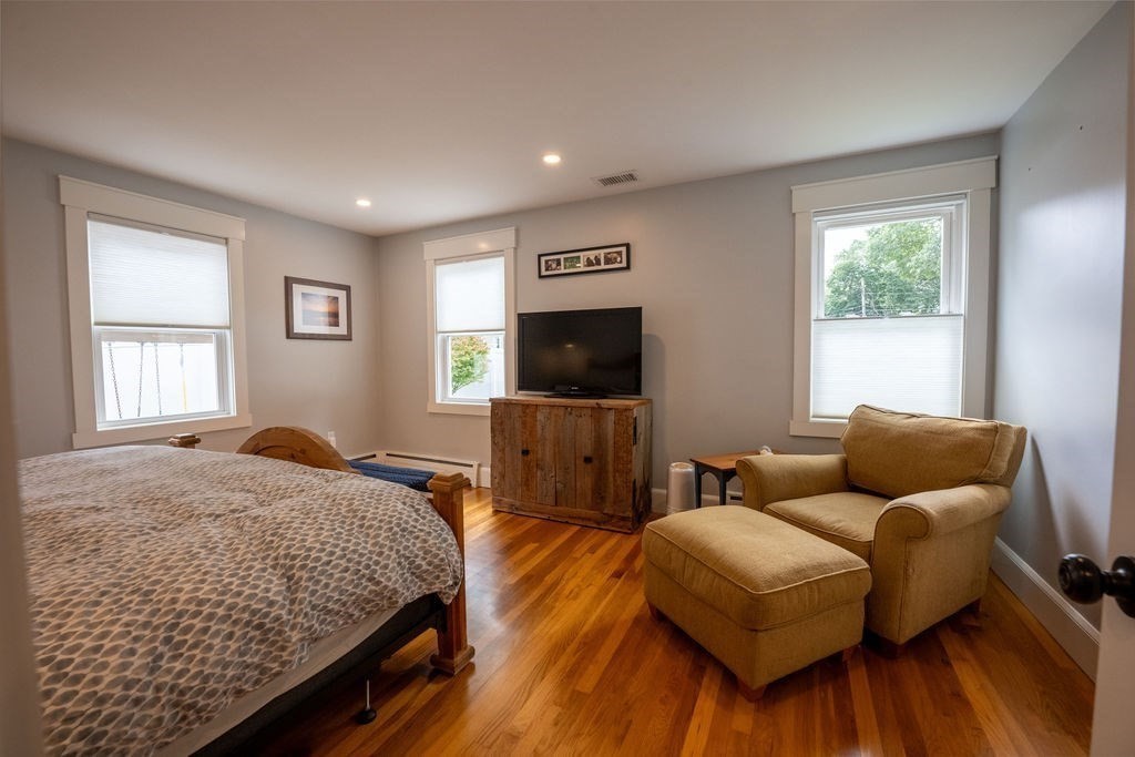 18 Belmore Road Natick, MA 01760 - Photo 13 of 30 a bedroom with a bed and wooden floor