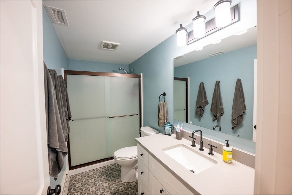 18 Belmore Road Natick, MA 01760 - Photo 14 of 30 a bathroom with a sink toilet and mirror