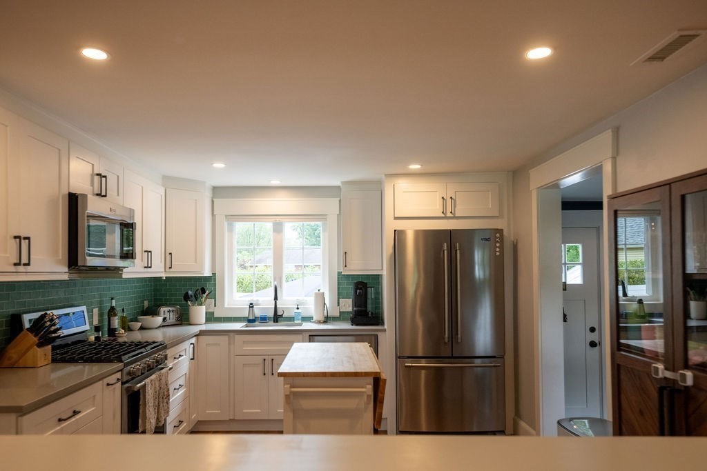 18 Belmore Road Natick, MA 01760 - Photo 20 of 30 a kitchen with stainless steel appliances granite countertop a refrigerator and a sink