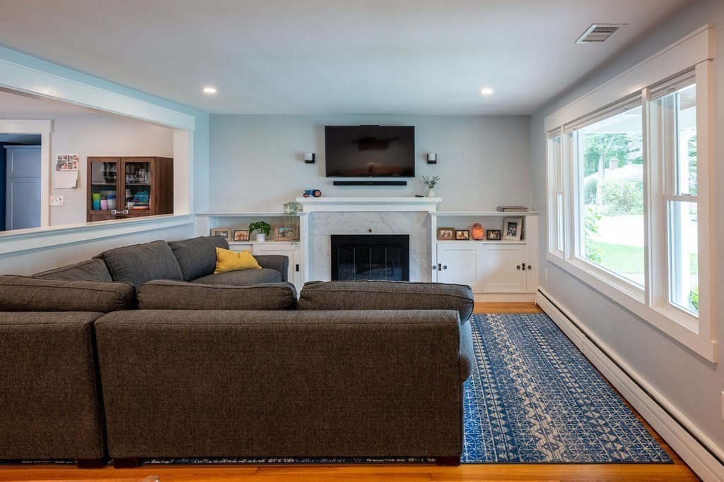 18 Belmore Road Natick, MA 01760 - Photo 22 of 30 a living room with furniture a flat screen tv and a fireplace