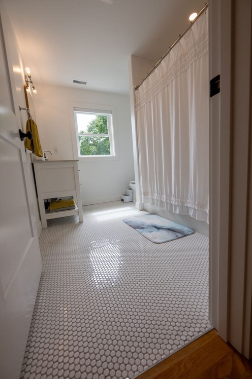 18 Belmore Road Natick, MA 01760 - Photo 26 of 30 a view of a bedroom with wooden floor and a window
