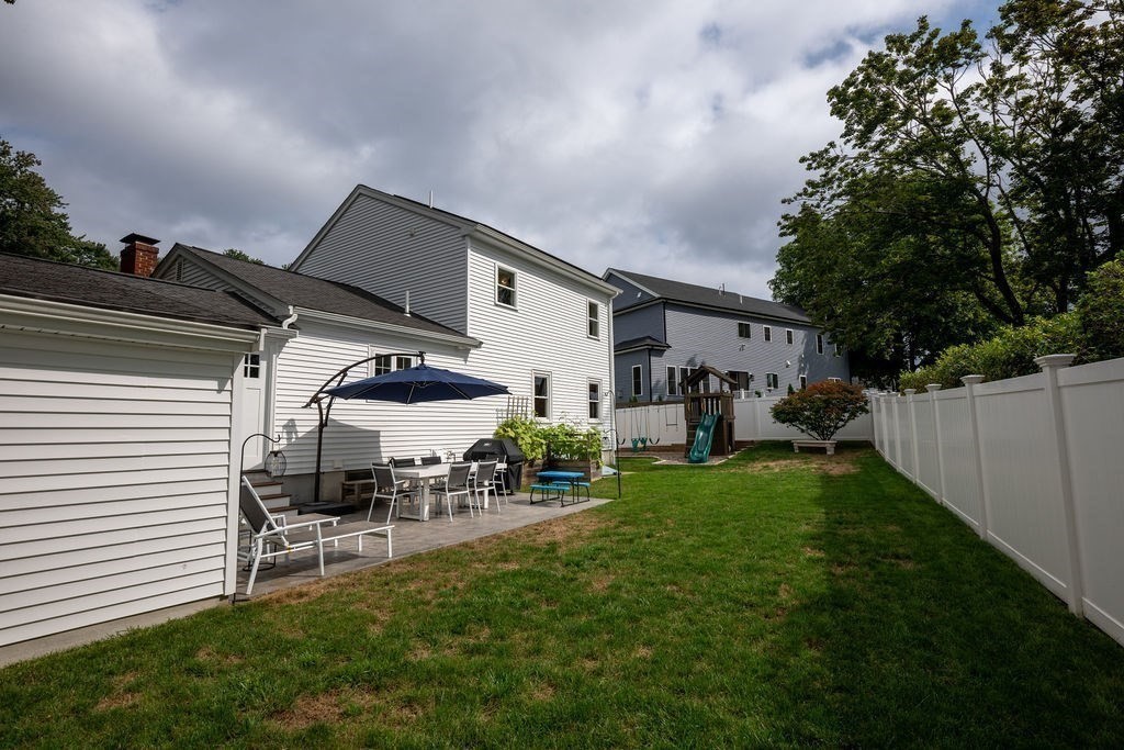 18 Belmore Road Natick, MA 01760 - Photo 5 of 30 a view of a patio with table and chairs potted plants with wooden fence