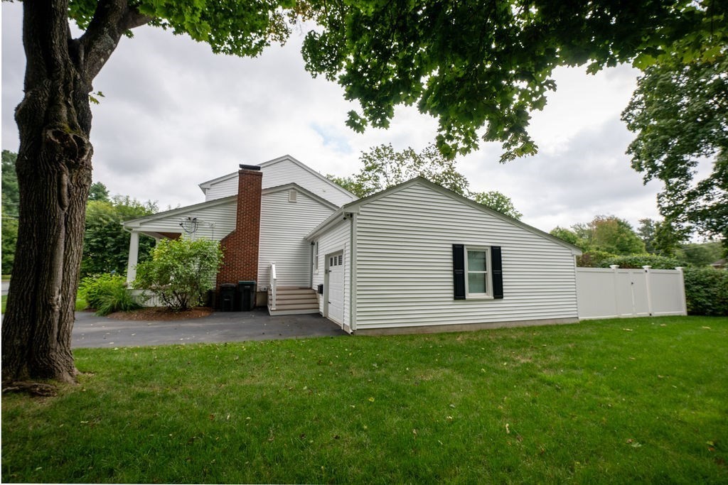 18 Belmore Road Natick, MA 01760 - Photo 7 of 30 a backyard of a house with table and chairs
