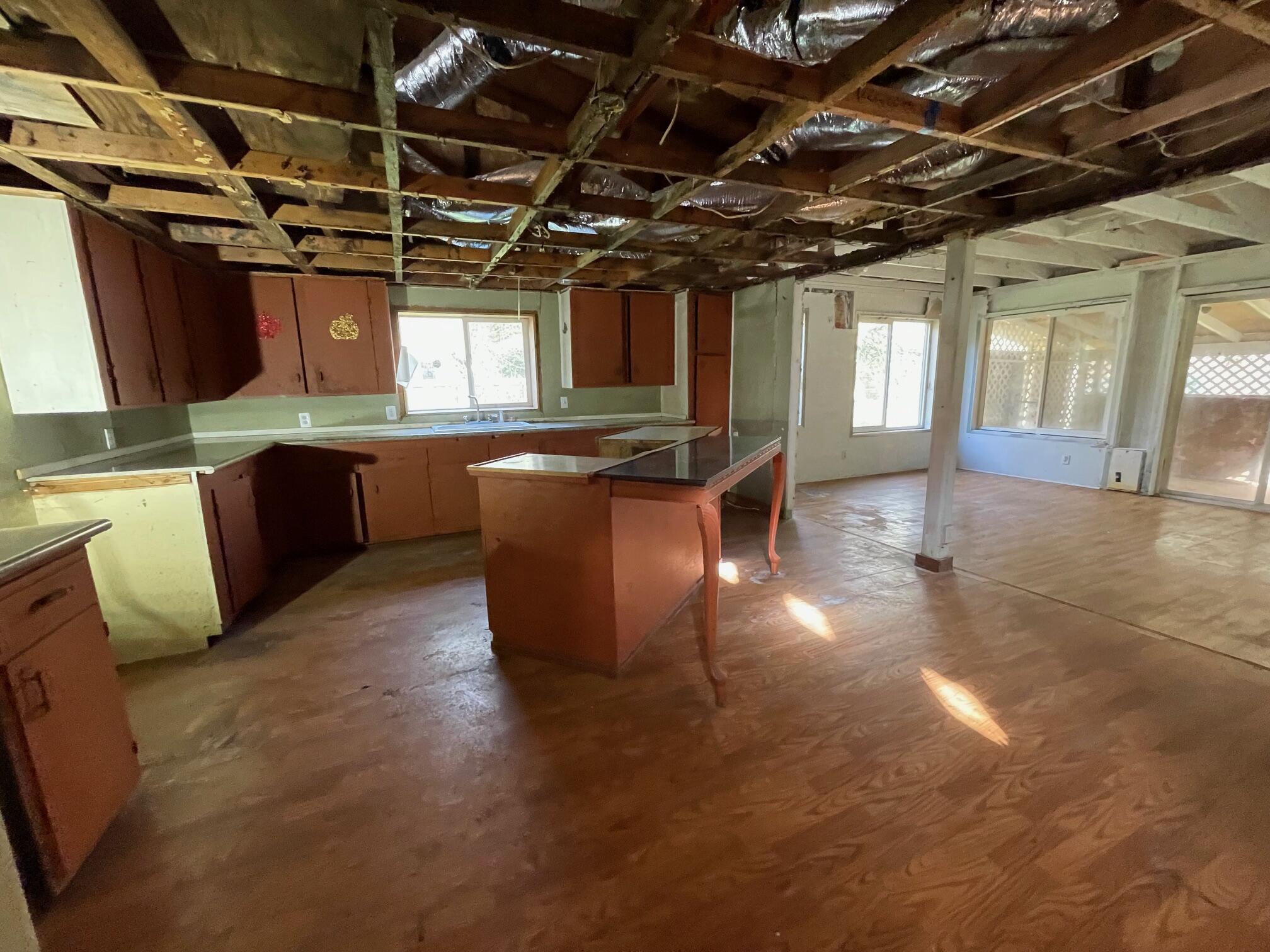 411 South Old Stage Road Cave Junction, OR 97523 - Photo 15 of 39 a view of a room with lots of wooden furniture and windows