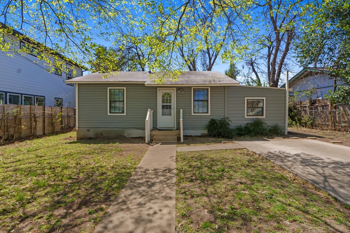 1709 Patton Lane Austin, TX 78723 - Photo 1 of 1 a front view of a house with a garden