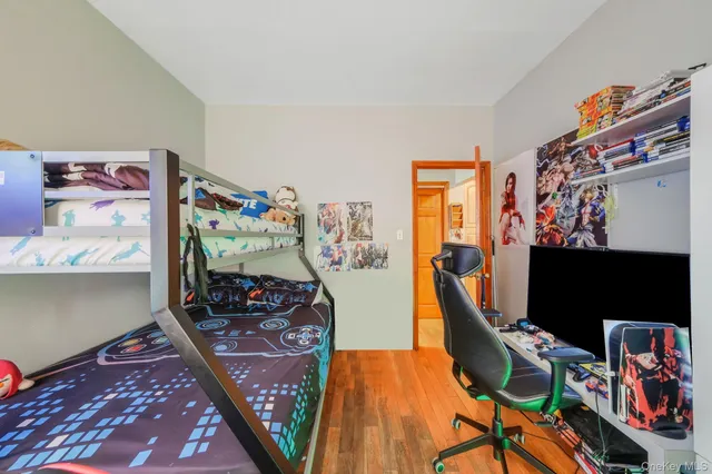 a bedroom with furniture and a flat screen tv