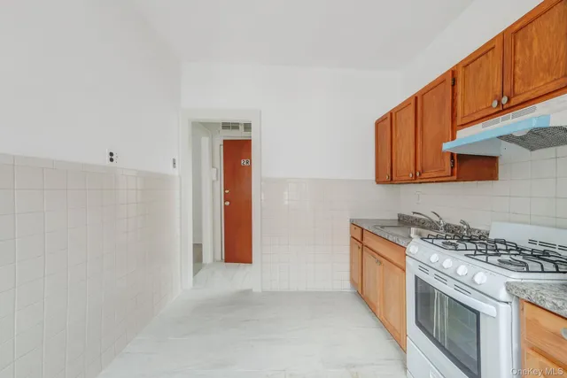 a kitchen with stainless steel appliances granite countertop a stove and a refrigerator