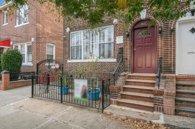a view of a brick house with large windows