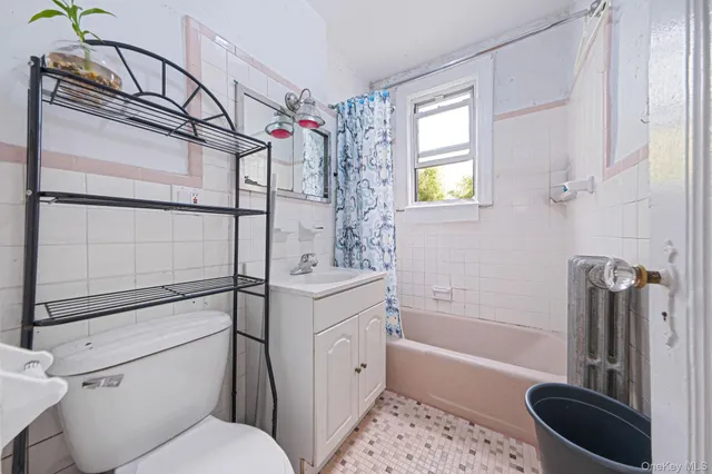 a bathroom with a toilet a sink and bathtub