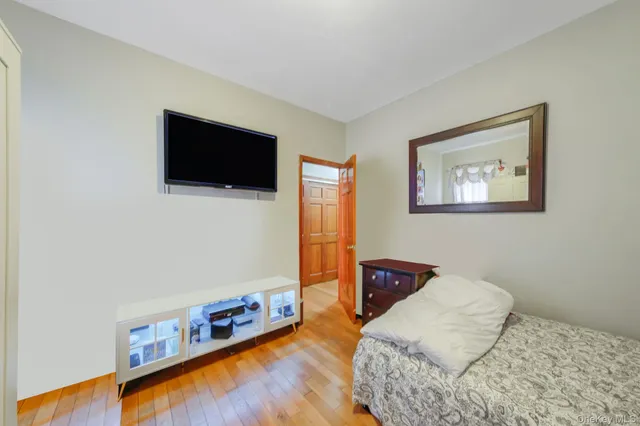 a bedroom with a bed and a flat screen tv