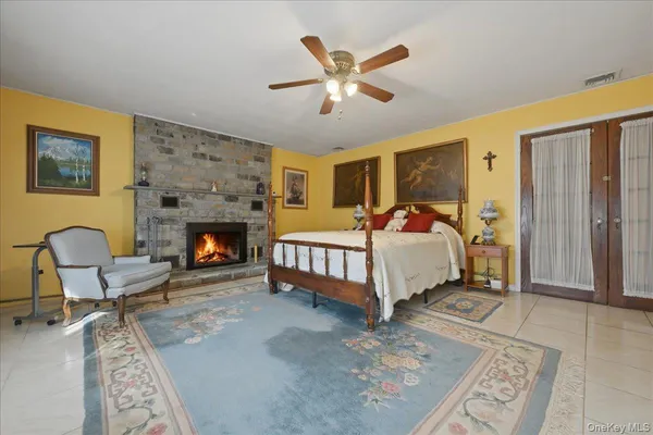a bedroom with a bed chairs and a table