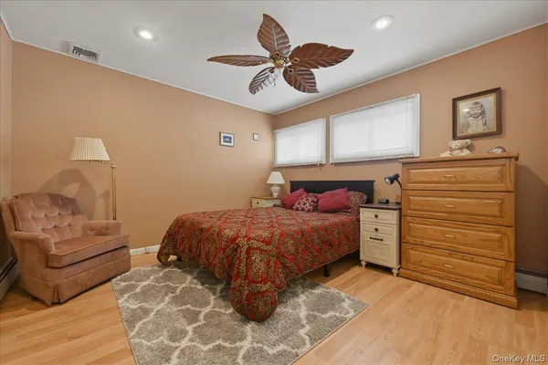 a bedroom with a bed and ceiling fan