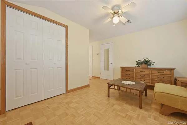 a view of a workspace with furniture and a chandelier fan