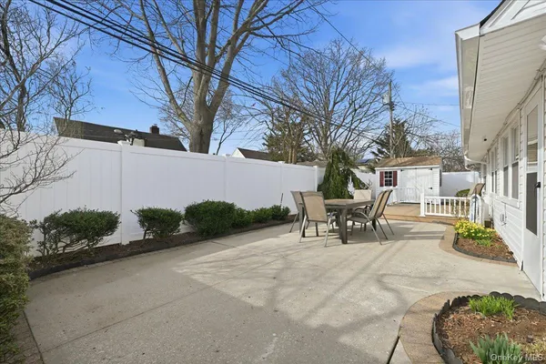 a view of a patio with a table and chairs