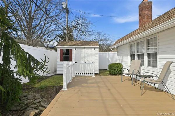 a backyard of a house with table and chairs and potted plants