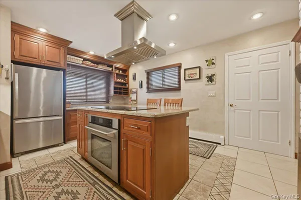 a kitchen with stainless steel appliances granite countertop a refrigerator and a stove