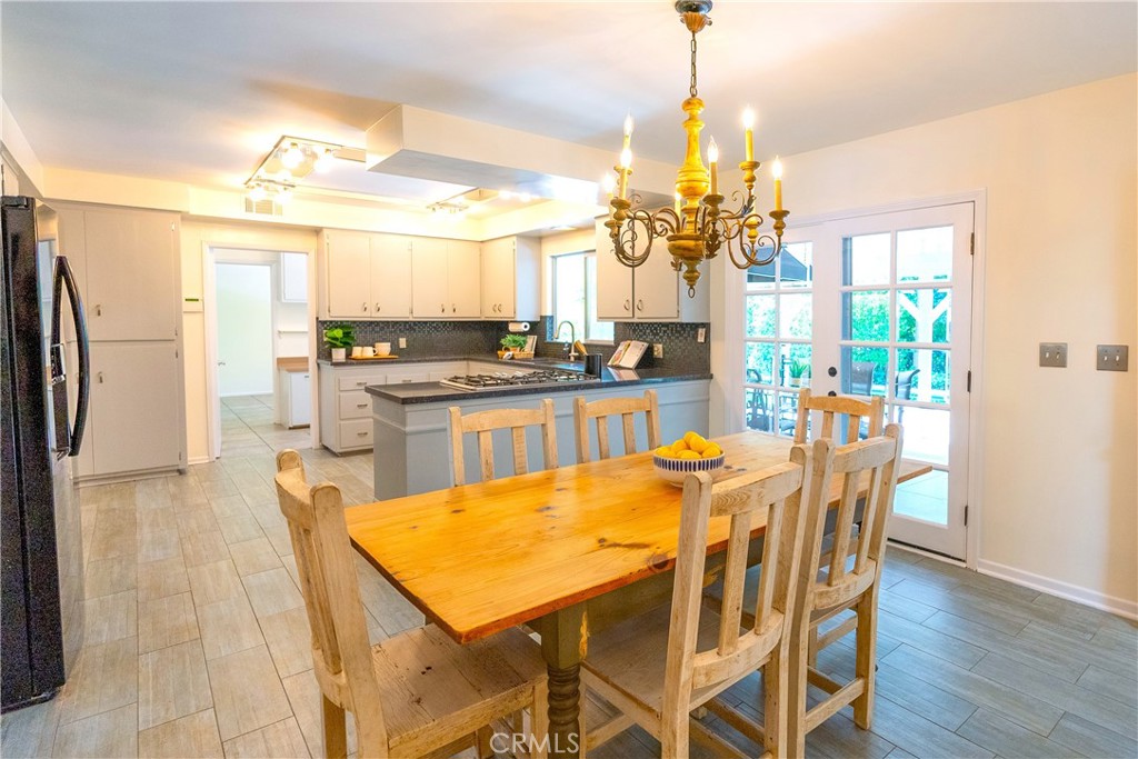 4669 Arriba Drive Tarzana, CA 91356 - Photo 11 of 22 a dining room filled with furniture and a chandelier