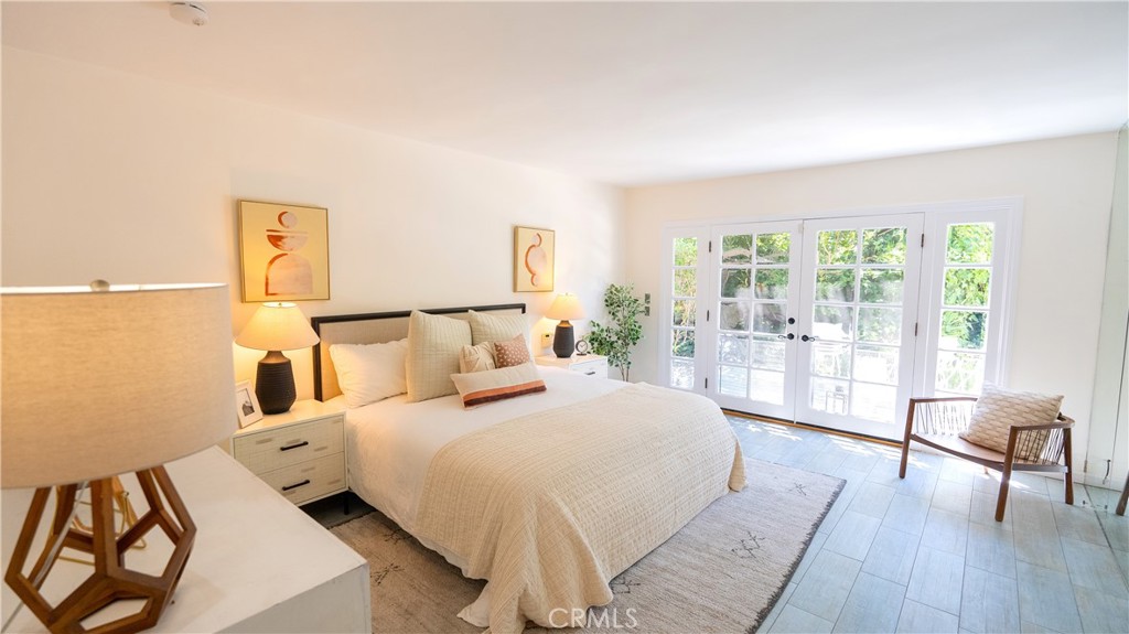 4669 Arriba Drive Tarzana, CA 91356 - Photo 13 of 22 a bedroom with a bed and a large window