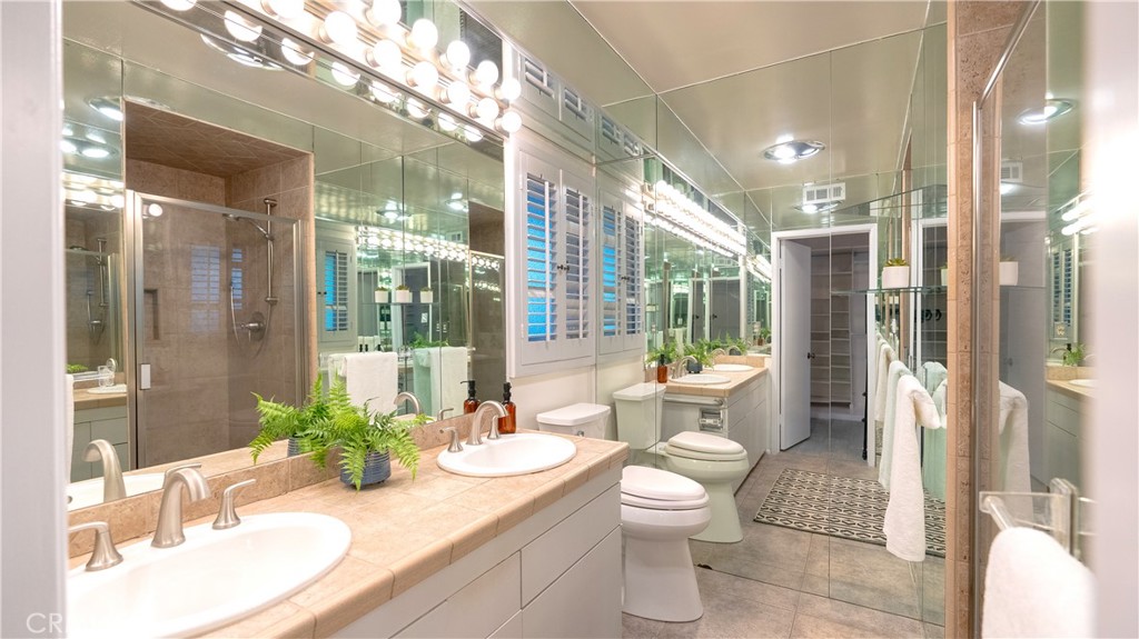 4669 Arriba Drive Tarzana, CA 91356 - Photo 15 of 22 a bathroom with a sink and mirror with toilet