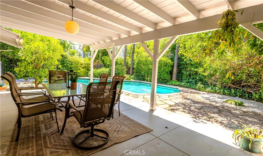 4669 Arriba Drive Tarzana, CA 91356 - Photo 20 of 22 a view of a porch with chairs and backyard