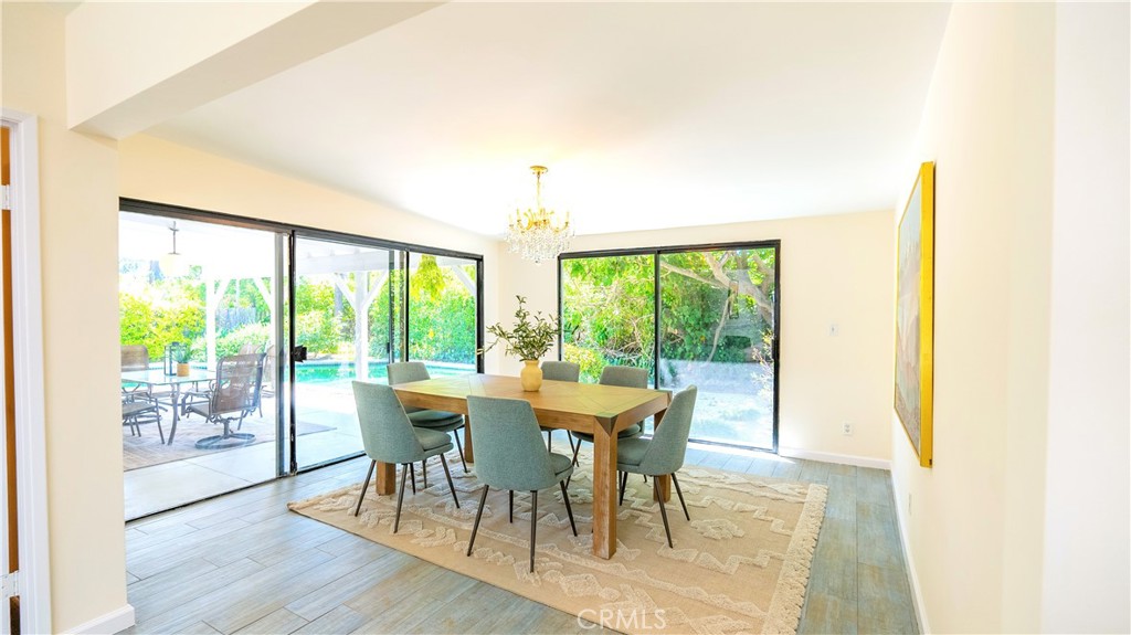 4669 Arriba Drive Tarzana, CA 91356 - Photo 9 of 22 a view of a dining room with furniture and wooden floor