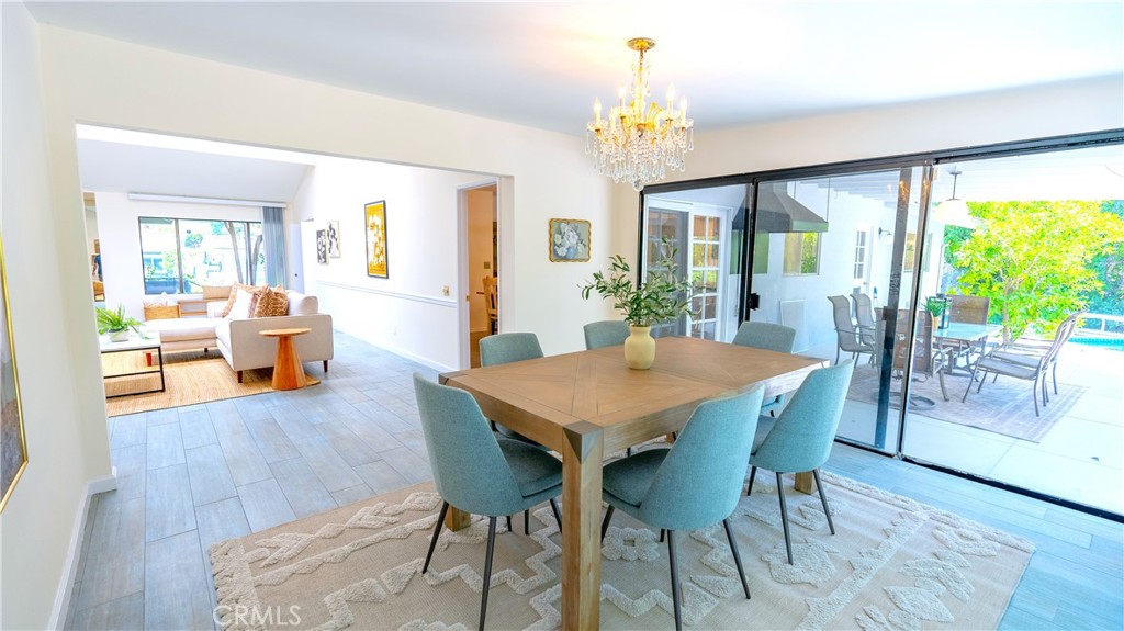 4669 Arriba Drive Tarzana, CA 91356 - Photo 10 of 22 a view of a dining room with furniture wooden floor and chandelier