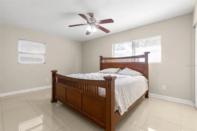 a bed sitting in a bedroom next to a window