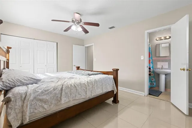 a spacious bedroom with a bed and a chandelier