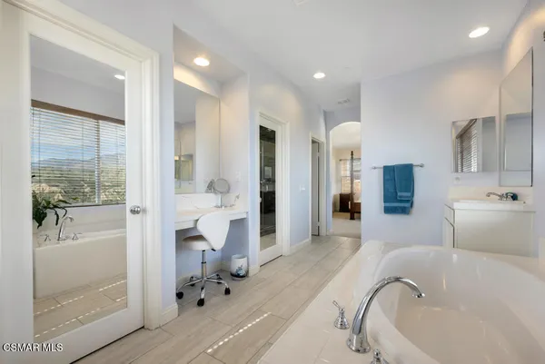 a bathroom with a tub shower and sink