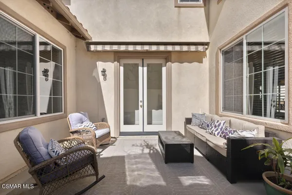 a view of a patio with table and chairs and potted plants