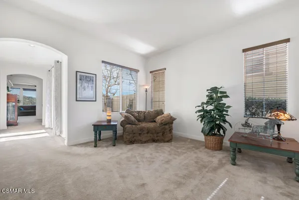 a living room with furniture and potted plant