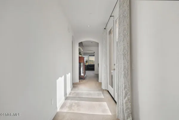 a view of a hallway with wooden floor and entryway